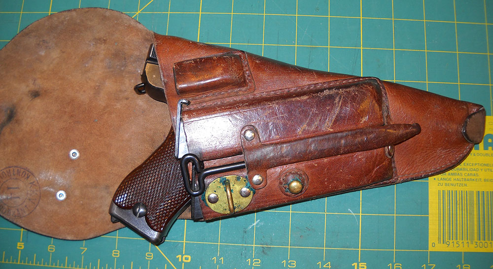 Finnish military-style L-35 pistol holster, with pistol and accessories, flap open